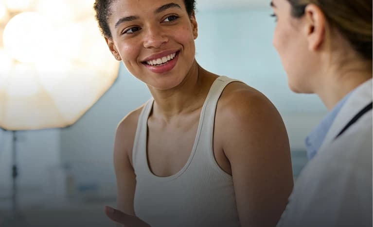 Smiling patient talking with her provider during a weight loss check-in