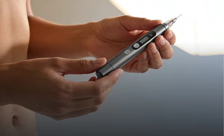 Hands holding a weekly GLP-1 injection pen